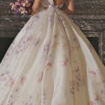 A woman in a Quinceanera dress standing in front of a fireplace