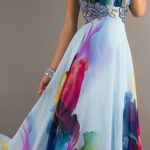 A woman in a colorful Quinceanera dress holding a cell phone