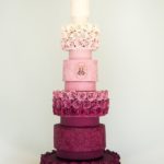 Quinceanera cake, a three tiered cake with a candle on top of it