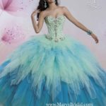 A woman wearing a blue and green Quinceanera ball gown