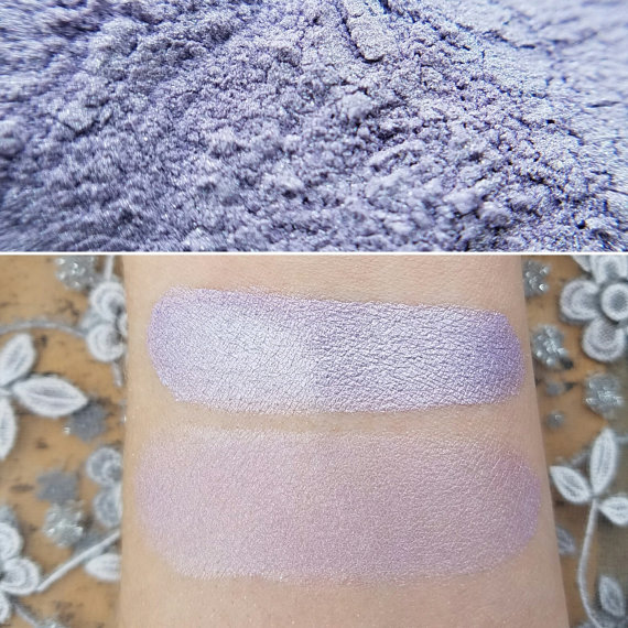 A close up of a person's arm with lilac Makeup and purple powder on it for a Quinceanera.