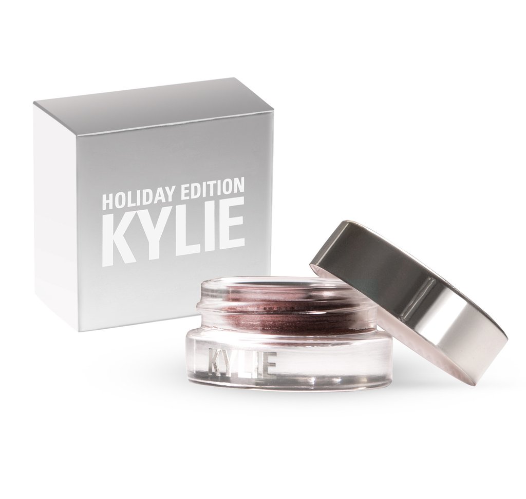 A small jar of Kylie Cosmetics eye shadow next to a box of Quinceanera cosmetics