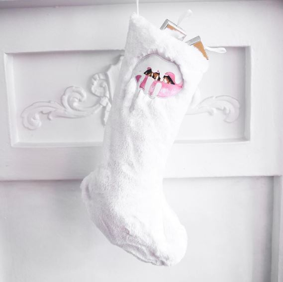 A white Christmas stocking with Kylie Cosmetics logo hanging from a door for Quinceanera