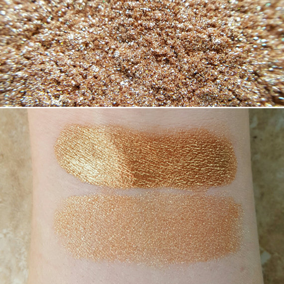 A close up of a person's arm with two different shades of glitter makeup for a Quinceanera.