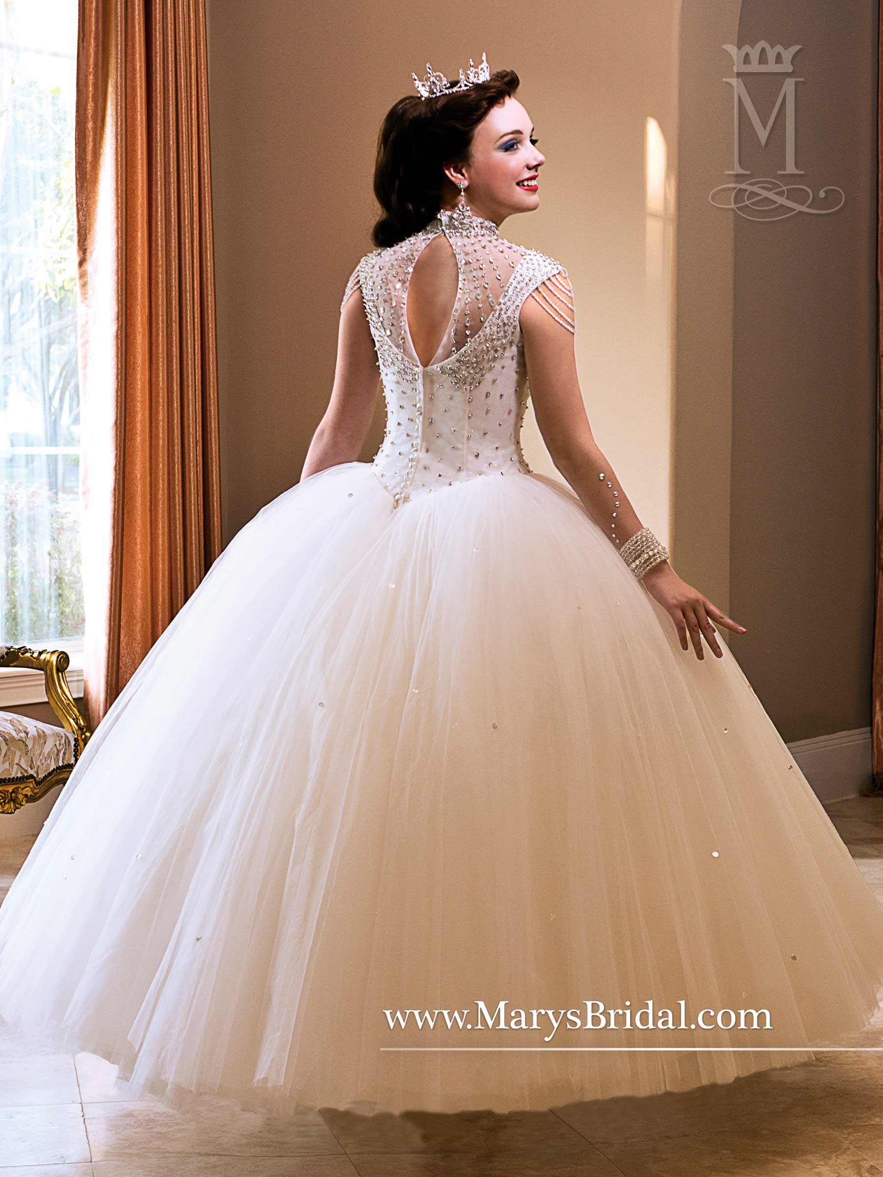 Princess themed quincea&ntilde;era dresses, a woman in a Quinceanera dress standing in a room