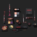 A collection of Reina Rebelde makeup and cosmetics items on a black background, inspired by Quinceanera