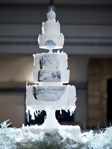 Quinceanera cake, a three tiered cake with frosting on a table in a winter wonderland theme