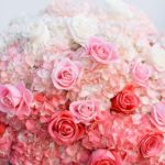 Floral design, a vase filled with pink and white flowers for a Quinceanera celebration with a pink ombre theme
