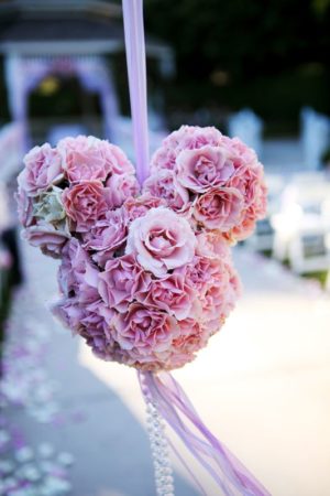 Quinceanera image: a heart shaped flower arrangement hanging from a string in a Disney wedding theme