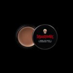 Quinceanera image featuring a small jar of face powder on a black background