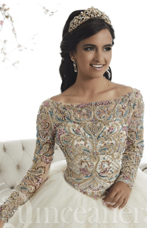 A woman in a Quinceanera gown sitting on a couch