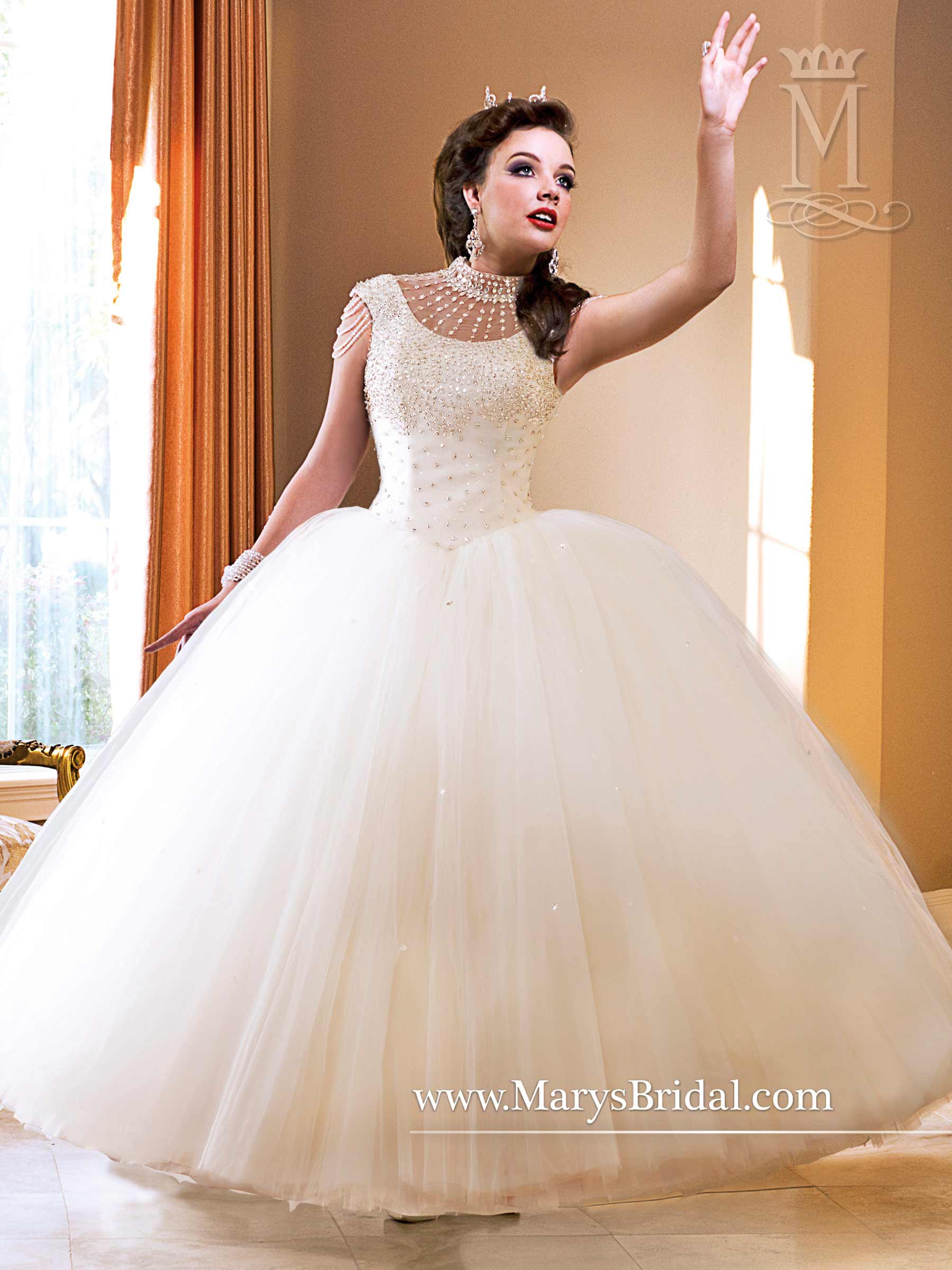 A woman in a wedding dress is waving at a crowd while wearing gorgeous Quincea&ntilde;era dresses.