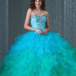 Quinceanera gown - A woman in a blue dress posing for a picture