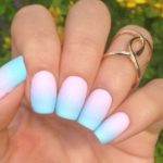 A person holding a blue and pink manicure with pastel color nail designs for Quinceanera