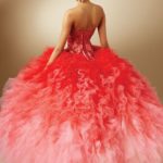 Quinceanera gown - a woman in a red and pink dress