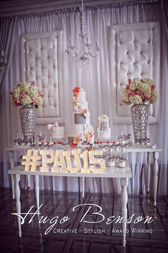 A Quinceanera function hall with a table decorated with a cake and flowers