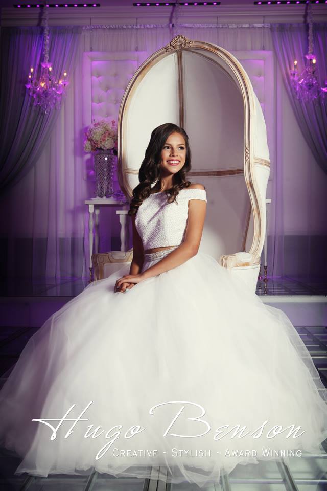 Quinceanera: A woman in a white gown sitting on a chair