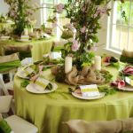 Quinceanera table with a tablecloth and a bunch of plates on it.