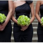 A group of women holding bouquets of green flowers for a Quinceanera