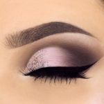A close up of a woman's eye with a purple eyeshadow ideal for Quinceanera