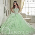 A woman in a Quinceanera gown standing in a room