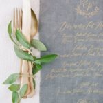 A table setting with silverware and cut flowers, perfect for a Quinceanera celebration.