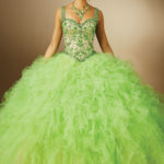A woman in a green dress posing for a picture, wearing Quinceanera dresses called verde limon vestidos de 15 años