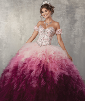 A woman in a pink and purple ombre Quinceañera dress posing for a picture