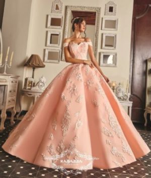 A woman in a pink Japanese Quinceañera dress standing in a room
