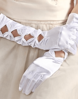 A woman in a white dress and white gloves holding a glove