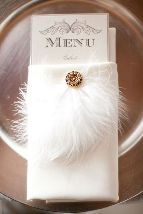 Quinceanera, a plate with a menu and a feather on it