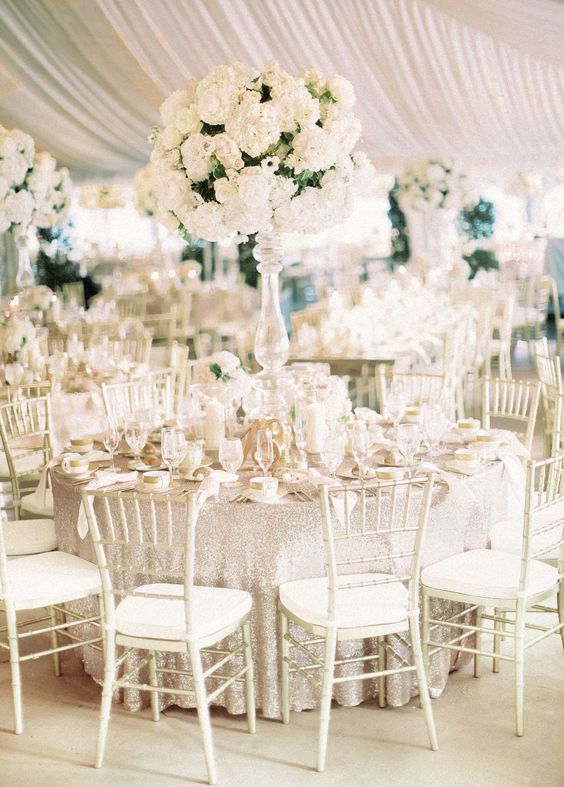 Quinceanera, a Quinceanera reception with white flowers, white chairs, and all white decor