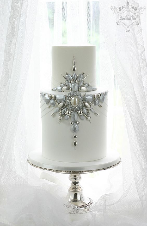 A jewelled Quinceanera cake, a white Quinceanera cake with a snowflake decoration