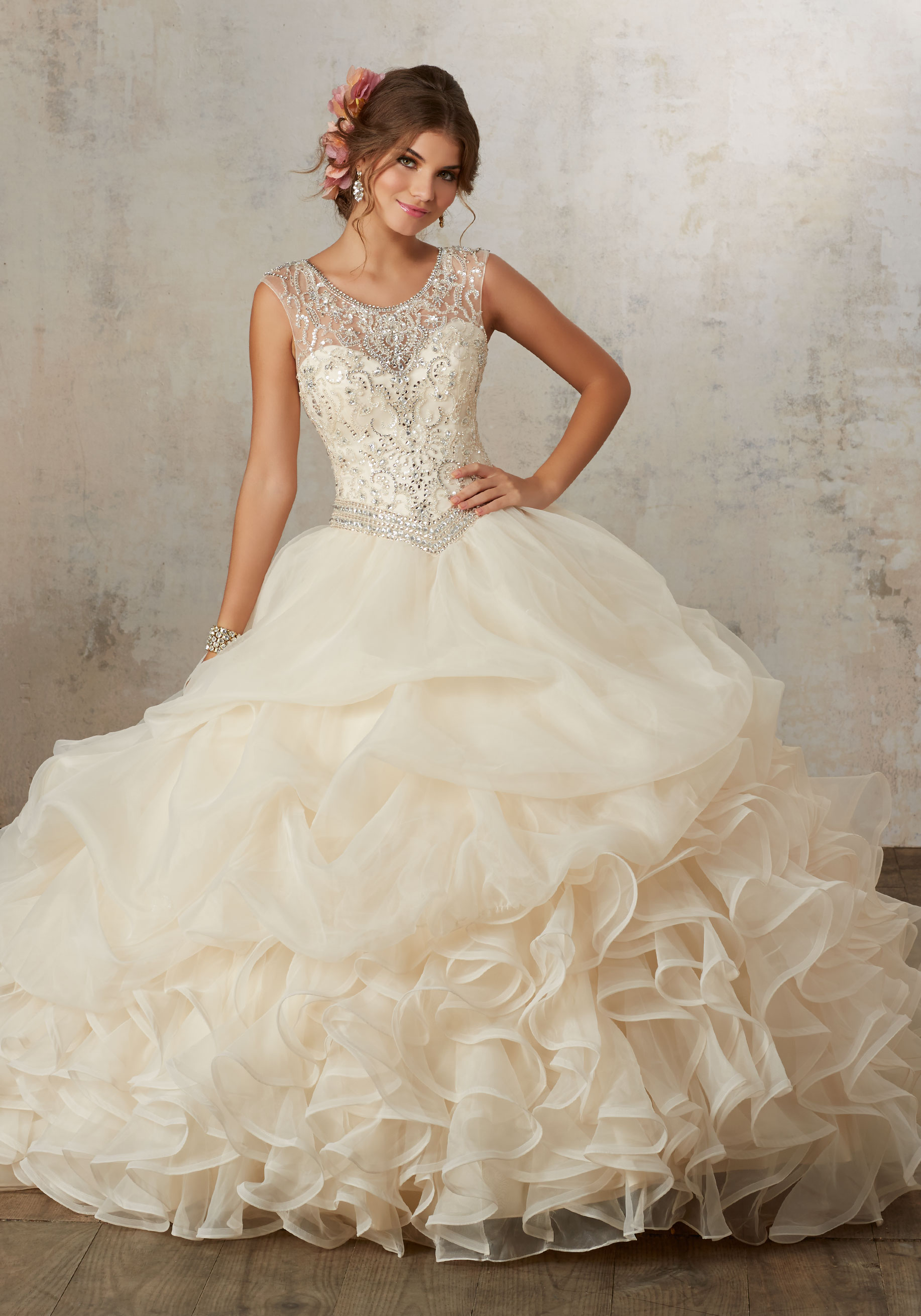 A woman in a quinceanera dress standing on a set of stairs