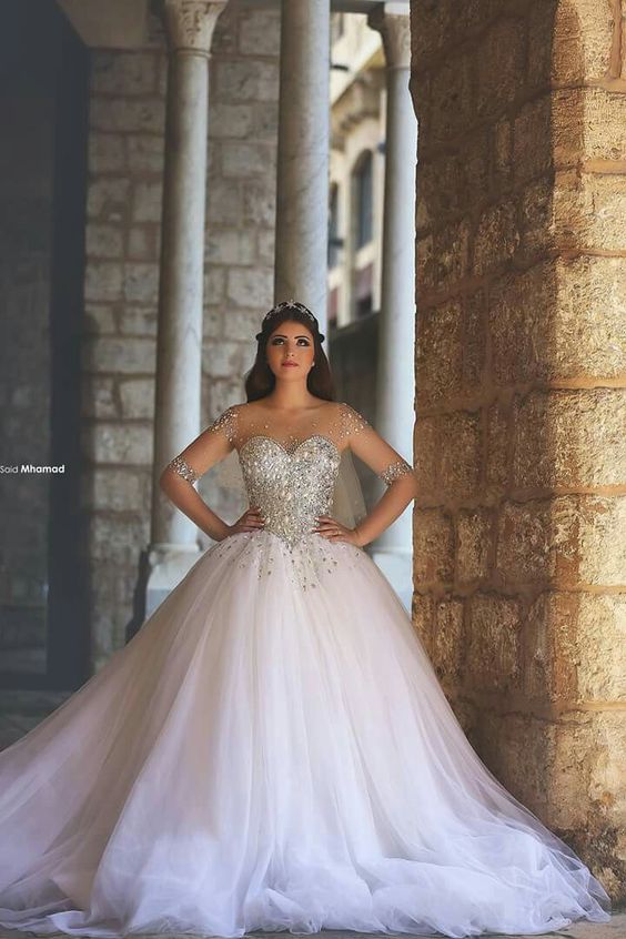 A woman in a Quinceanera dress posing for a picture