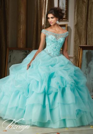 A woman in a purple Quinceanera gown posing for the camera