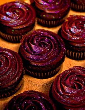 A bunch of Quinceanera cupcakes with edible glitter, sitting on a table