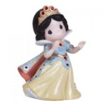 A Precious Moments figurine of a snow queen with a flute, perfect for a Quinceanera celebration