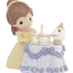 Quinceanera figurine, a figurine of a little girl sitting at a table