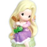 A Quinceanera figurine of Rapunzel, a little girl sitting on a bench