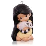A precious moments Quinceanera ornament featuring a small figurine of a girl holding a cat