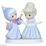 A Quinceanera figurine doll and a couple of figurines standing next to each other