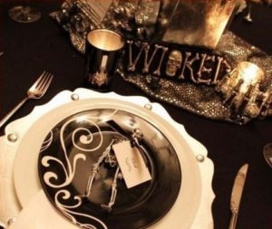 Quinceanera themed chocolate Halloween table decor, featuring a black and white table setting with silverware
