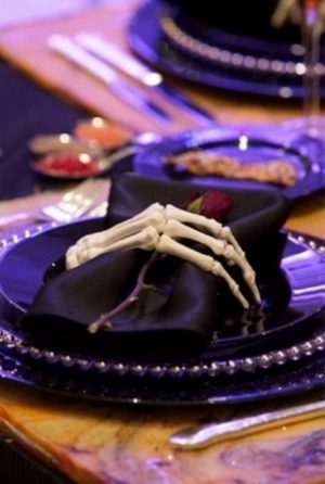 Quinceanera, a table setting with a purple plate and a skeleton napkin, Halloween decoration ideas