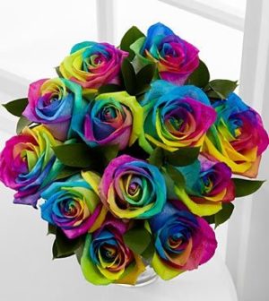A colorful bouquet of roses, known as Rainbow rose, displayed on a table at the Moon Indian Restaurant during a Quinceanera celebration.