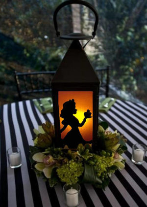Quinceanera table centerpieces: A table with a lantern featuring a silhouette of a princess on it.