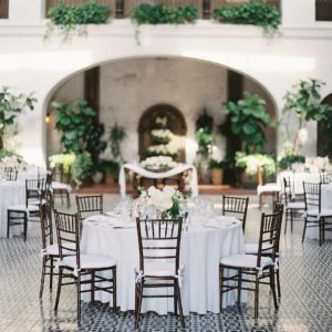 A table set up for a Quinceanera reception in a courtyard
