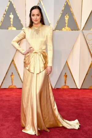 Dakota Johnson, a woman in a gold Quinceanera dress on a red carpet