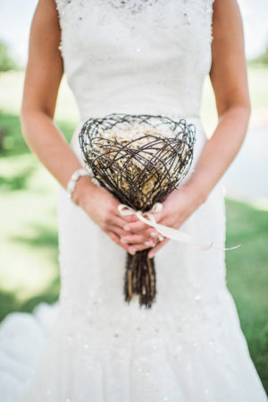 A woman in a Quinceanera gown holding a bouquet