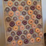 A display of petit four and doughnuts on a wooden board for a Quinceanera celebration